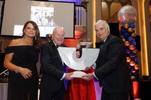 Shannon Chamber founding director Mick Guinee is presented with a sculpture by independent sculptor Colin Grehan, from INStone Gallery in the Burren, by Chamber president Mark Nolan and CEO Helen Downes.